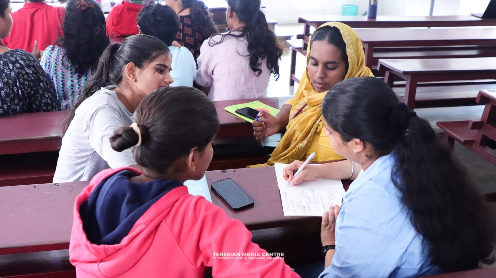 Students discussing and taking notes together during a bootcamp activity