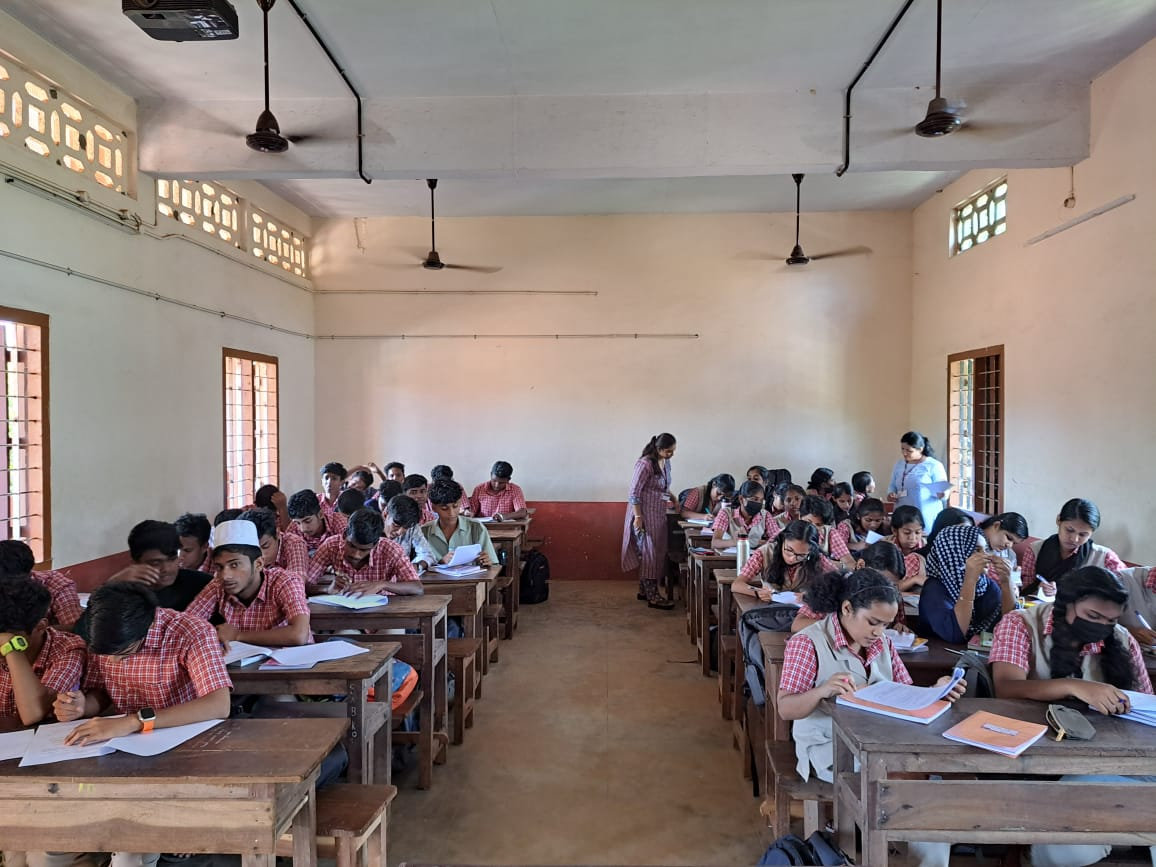 Students in a government school classroom in Kunnathunad filling in the survey